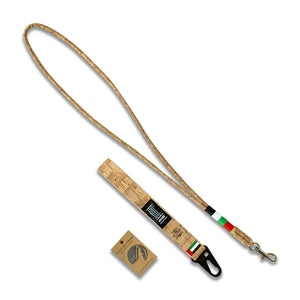image of the 3 National Day gift set items; 1 metal magnet with the UAE map silhouette, cork wrist strap keychain and a cork lanyard wrapped in thread of red, white, green and black. 